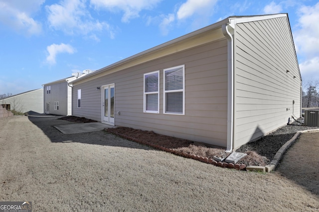 rear view of house with central AC unit