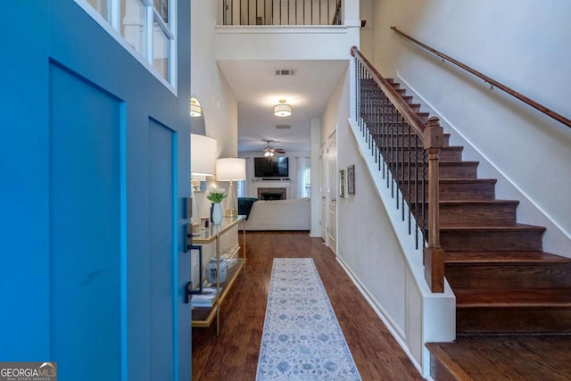 entrance foyer featuring dark hardwood / wood-style floors, a high ceiling, and ceiling fan