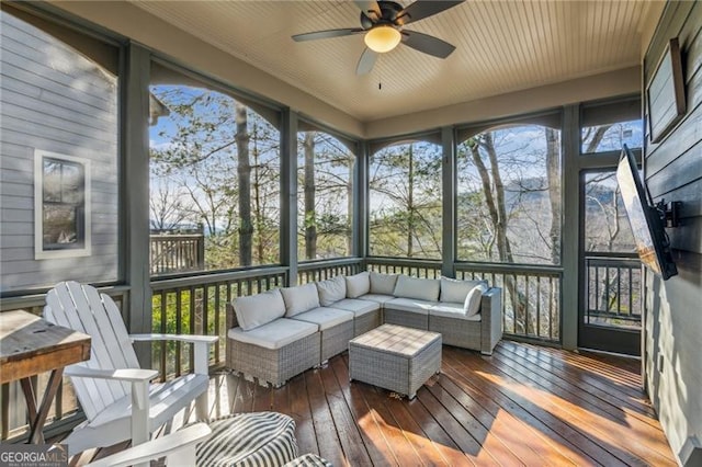 sunroom featuring ceiling fan