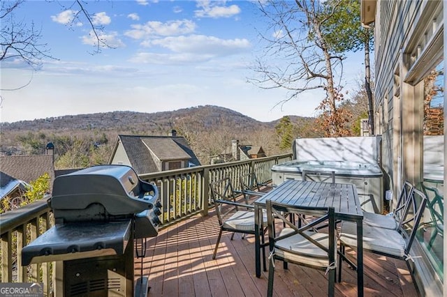 deck featuring a mountain view and a grill