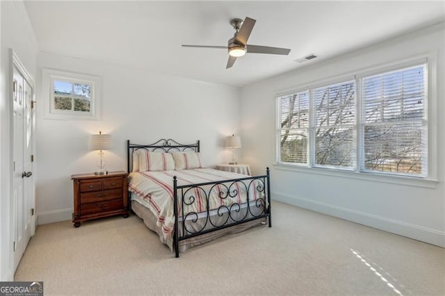 bedroom featuring ceiling fan and light carpet