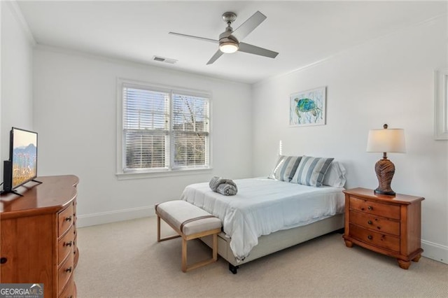 bedroom with ceiling fan, crown molding, and light colored carpet