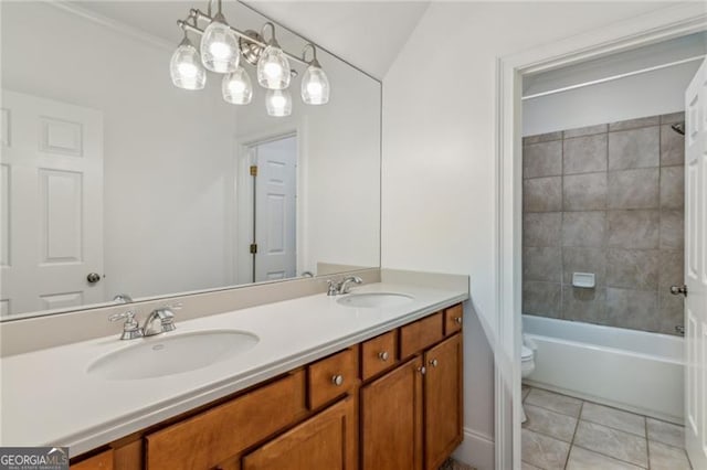 full bathroom with toilet, tile patterned flooring, tiled shower / bath, and vanity