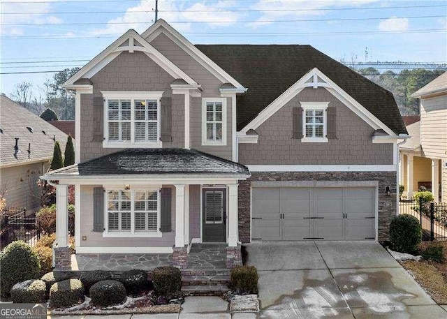 craftsman-style house featuring covered porch and a garage