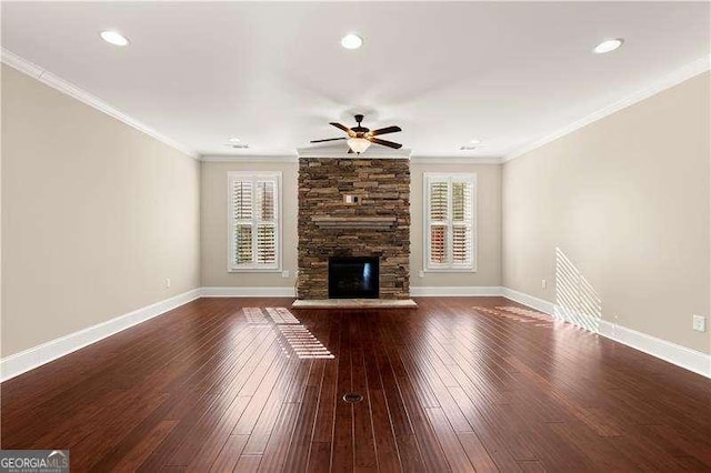 unfurnished living room featuring ceiling fan, dark hardwood / wood-style flooring, crown molding, and a fireplace