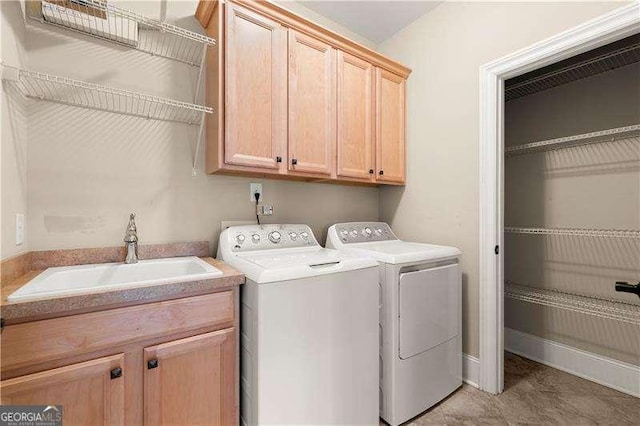 laundry area featuring cabinets, sink, and washing machine and dryer