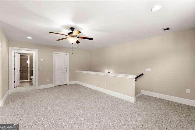 spare room with light carpet and ceiling fan