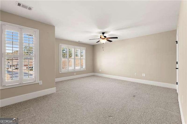 empty room with ceiling fan and light colored carpet