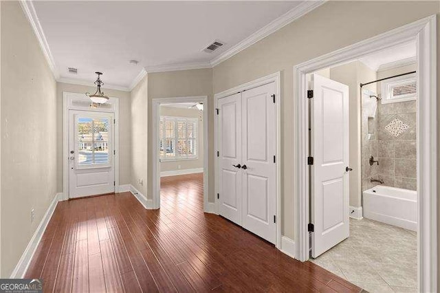 entrance foyer featuring wood-type flooring and ornamental molding