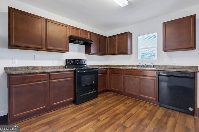 kitchen featuring dark wood-type flooring, sink, and black appliances