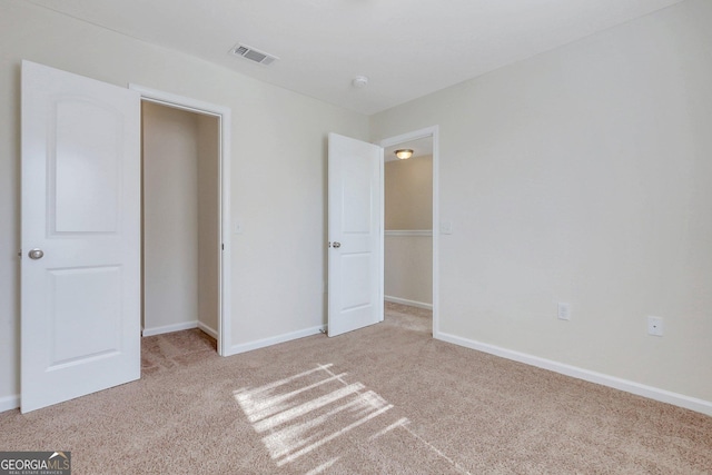 unfurnished bedroom with light colored carpet