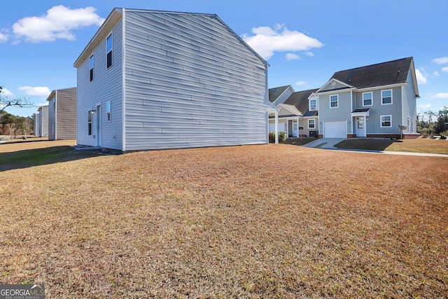 view of home's exterior featuring a lawn and a garage