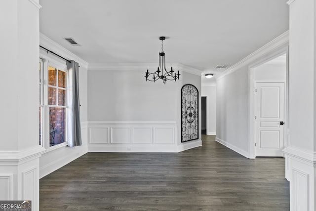 unfurnished dining area with a chandelier, crown molding, and dark hardwood / wood-style floors