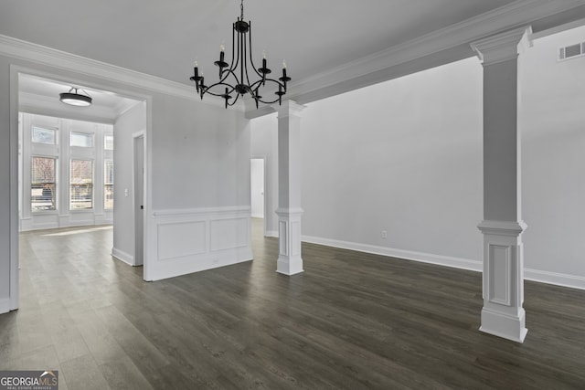 unfurnished dining area featuring crown molding, an inviting chandelier, and decorative columns