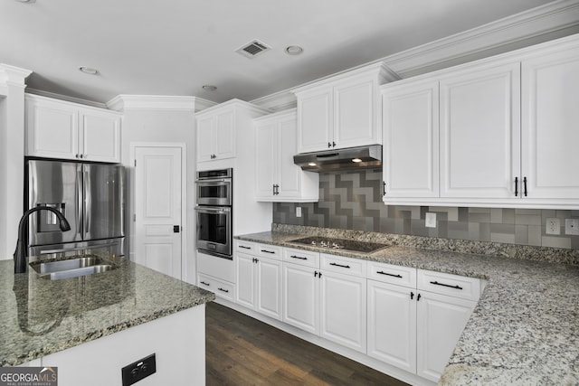 kitchen featuring stone counters, white cabinetry, stainless steel appliances, and sink