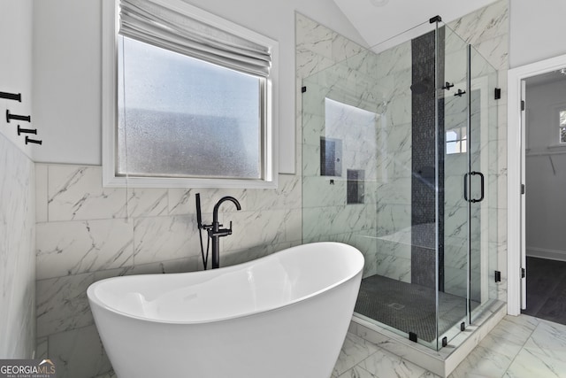 bathroom with lofted ceiling, tile walls, and shower with separate bathtub