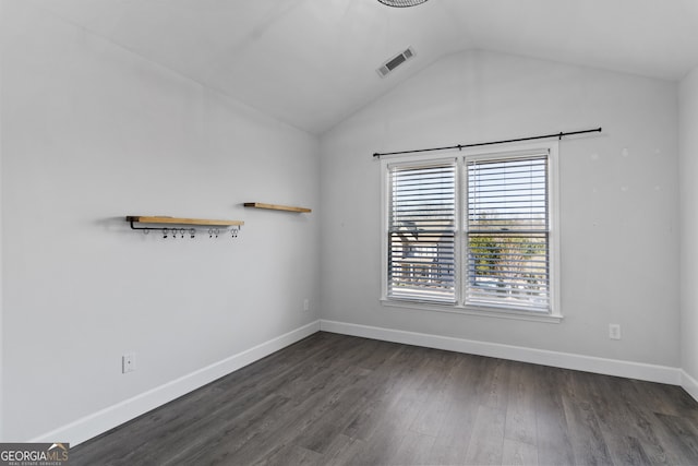 empty room with lofted ceiling and dark hardwood / wood-style floors