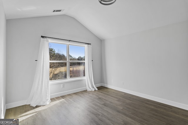 unfurnished room with lofted ceiling and wood-type flooring