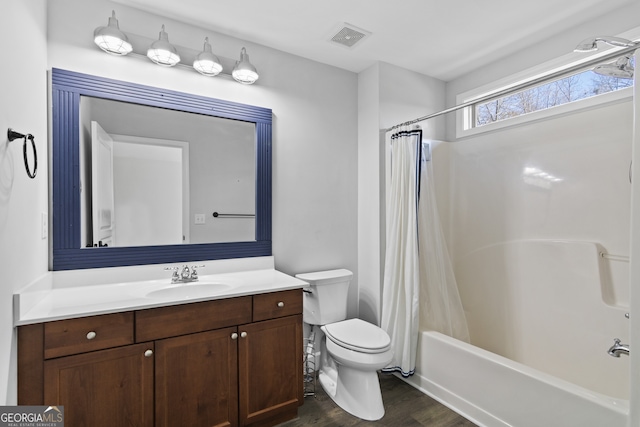 full bathroom featuring toilet, hardwood / wood-style floors, vanity, and shower / tub combo with curtain