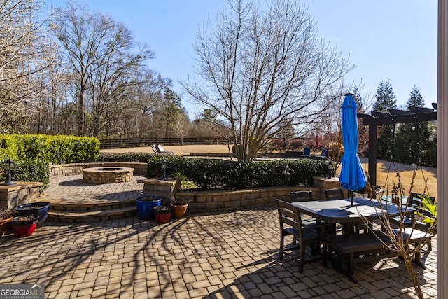 view of patio / terrace featuring an outdoor fire pit and a pergola