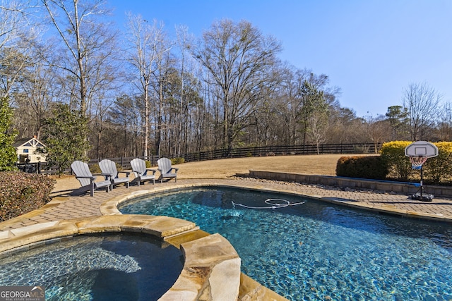 view of pool with an in ground hot tub