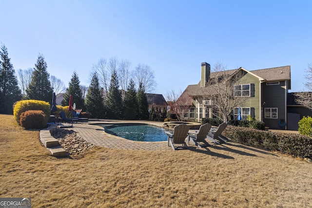 view of pool featuring a lawn