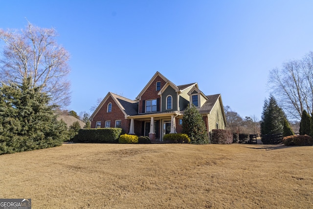 view of front facade featuring covered porch and a front yard