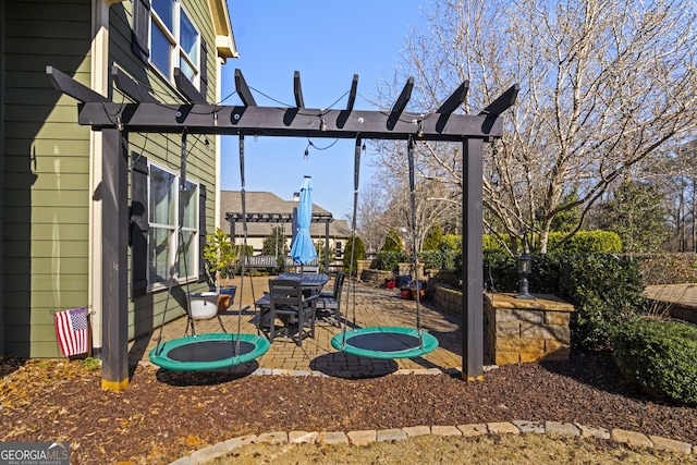 view of yard with a trampoline, a pergola, and a patio area