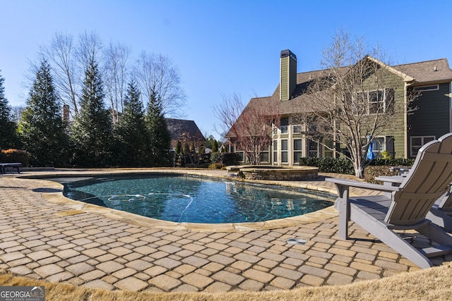 view of swimming pool with a patio area and an in ground hot tub