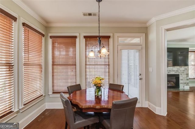 dining area with dark hardwood / wood-style flooring and ornamental molding