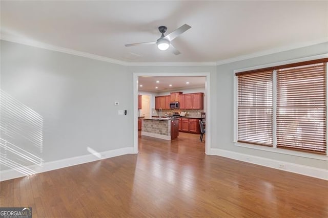 unfurnished living room featuring ceiling fan, light hardwood / wood-style flooring, and ornamental molding