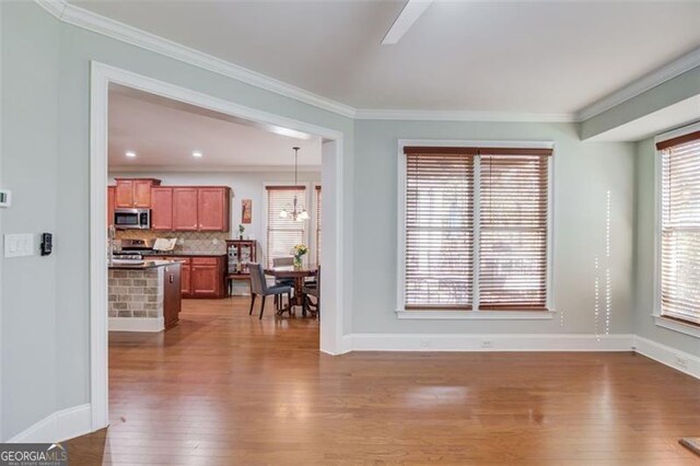 588 Myrtle Trace Ln, Suwanee, GA 30024 - living area featuring crown molding, baseboards, a chandelier, and hardwood / wood-style flooring