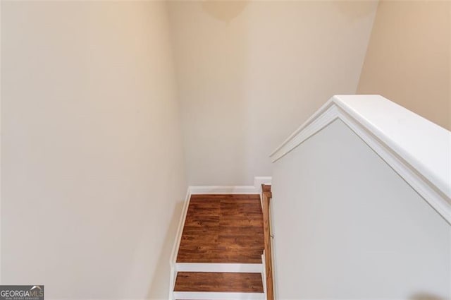 staircase with wood-type flooring