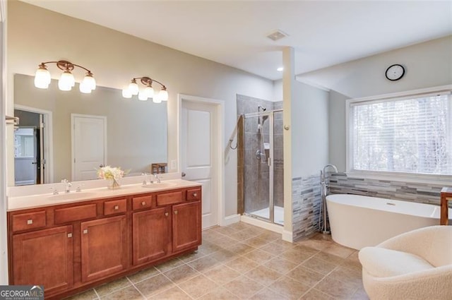 bathroom featuring separate shower and tub, vanity, and tile patterned flooring