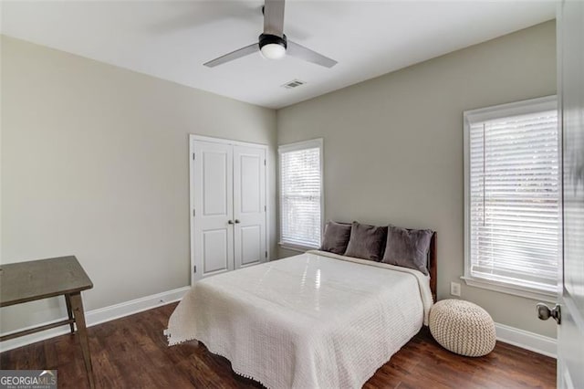 bedroom featuring ceiling fan, a closet, and dark hardwood / wood-style floors