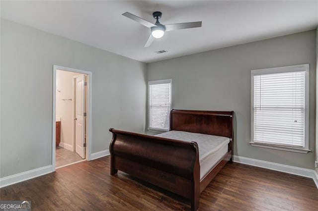 bedroom featuring ensuite bath, ceiling fan, and dark hardwood / wood-style floors