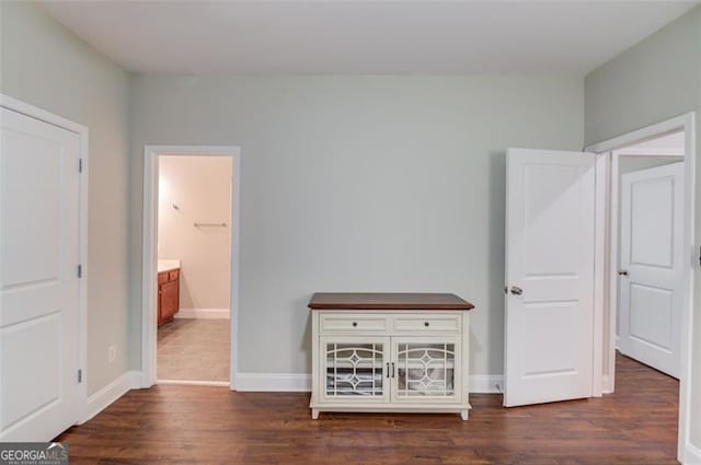 unfurnished bedroom featuring dark wood-type flooring