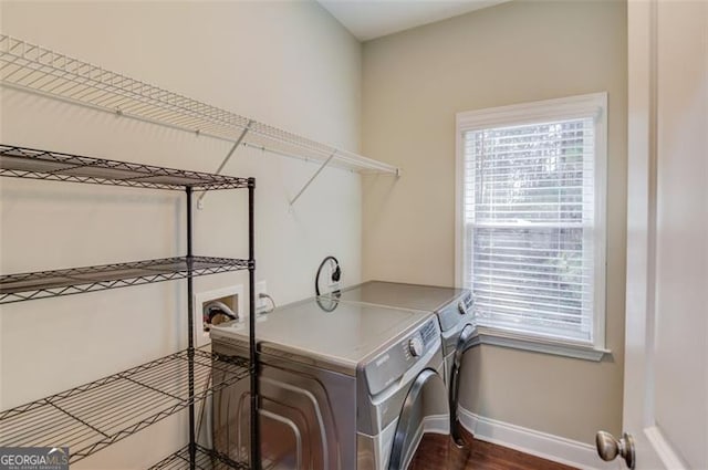 laundry area with washer and dryer and dark hardwood / wood-style floors