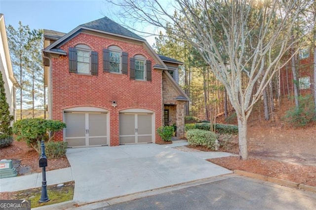 588 Myrtle Trace Ln, Suwanee, GA 30024 - traditional-style house featuring concrete driveway, brick siding, and a garage