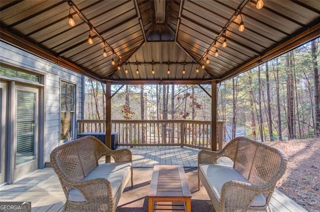 sunroom / solarium featuring lofted ceiling