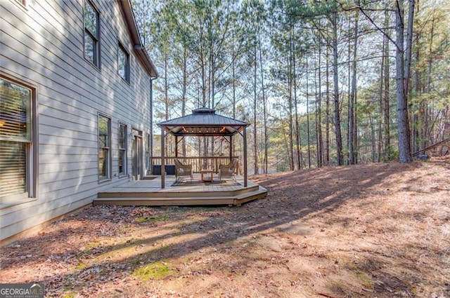 view of yard featuring a deck and a gazebo