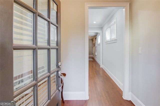 interior space featuring ornamental molding and hardwood / wood-style flooring