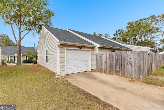 view of home's exterior with a garage and a lawn