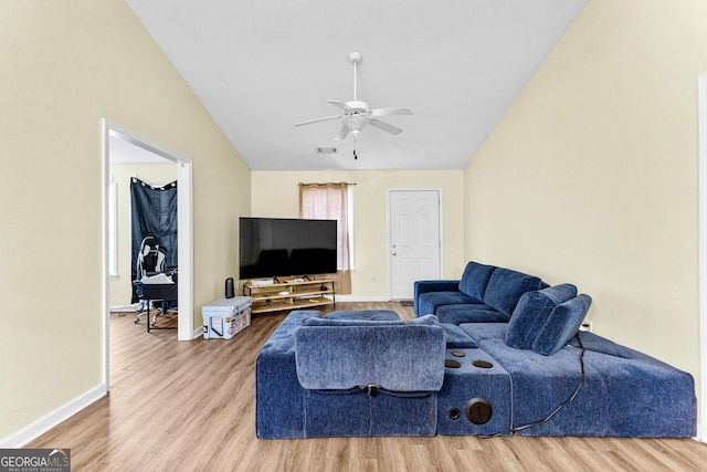 living room with ceiling fan, lofted ceiling, and hardwood / wood-style floors