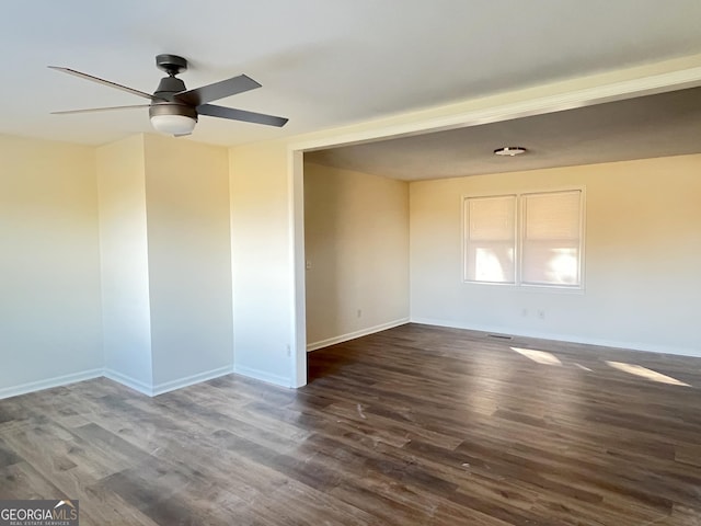 empty room featuring ceiling fan and dark hardwood / wood-style flooring