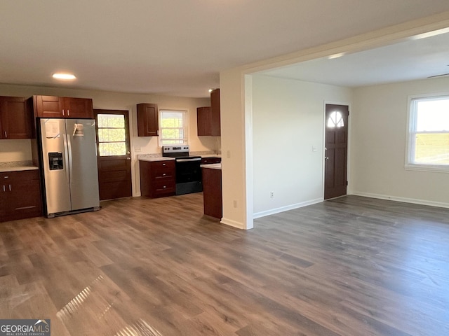 kitchen featuring appliances with stainless steel finishes and dark hardwood / wood-style flooring