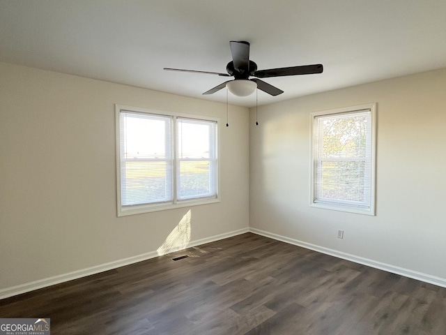 spare room featuring ceiling fan and dark hardwood / wood-style flooring