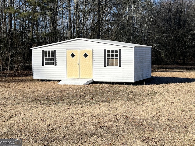 view of outdoor structure featuring a lawn