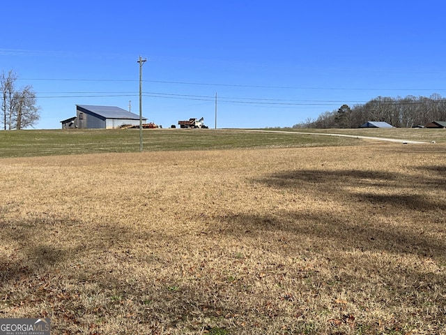 view of yard with a rural view