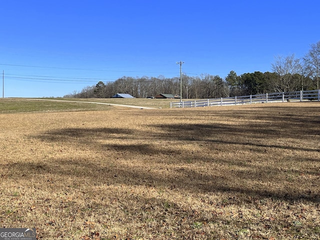 view of yard with a rural view